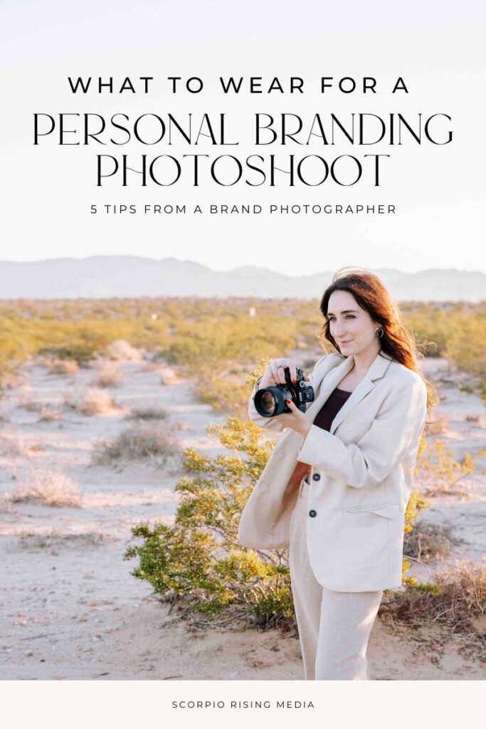 woman in a beige pantsuit with a camera in her hand looking off into the desert landscape with text that reads "what to wear for a personal branding photoshoot" 